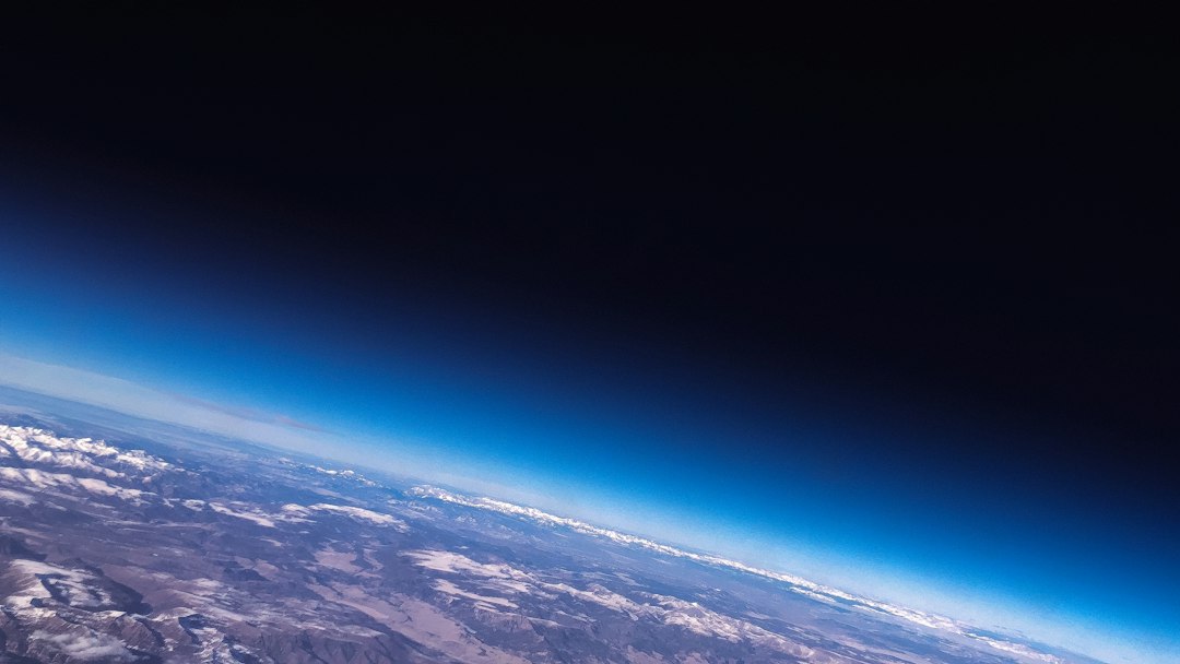 Earth viewed from space in a dark cinematic scene